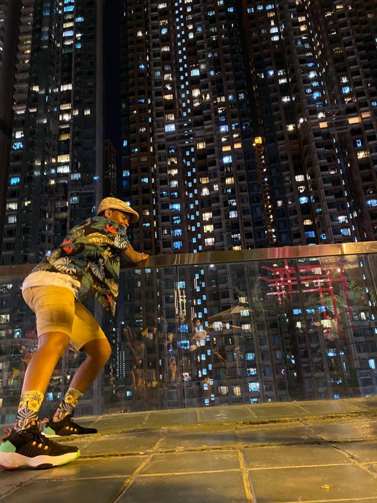 Leaning on a railing in the city at night